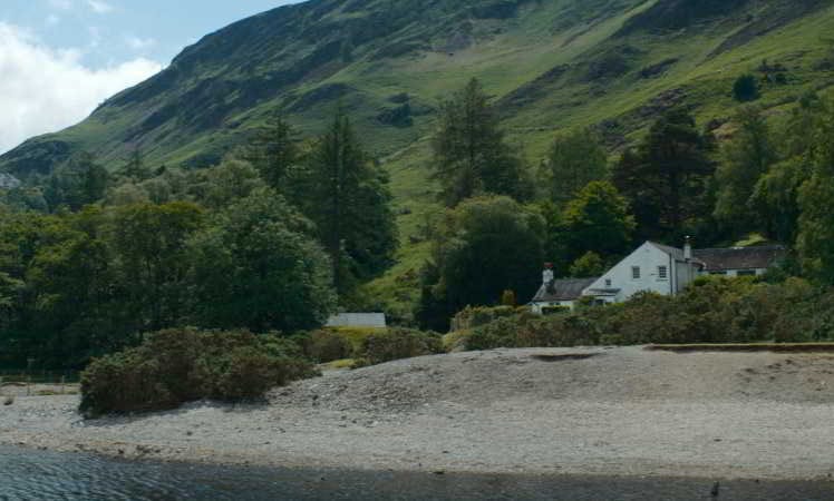 Schilderachtig landschap met een wit huis aan de voet van een groene heuvel, een locatie uit de Netflix-serie Missing You.